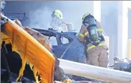  ?? JOE CASTRO VIA REUTERS ?? Emergency services personnel check the scene of the plane crash in Melbourne, Australia, on Tuesday.