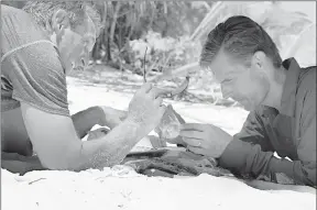  ??  ?? In this photo provided by the Discovery Channel, U.S. Sen. Jeff Flake, R-Ariz., left, and Martin Heinrich, D-N.M., attempt to start a fire while surviving on a remote Eru island, part of the Marshall Islands, for Discovery Channel’s Rival Survival.