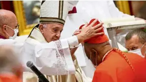  ??  ?? New beginning: Francis placing a biretta on Gregory’s head during the consistory ceremony at St Peter’s Basilica at the Vatican. — Reuters