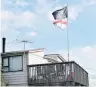  ??  ?? Rival flags wave above the News’ Dunedin house.