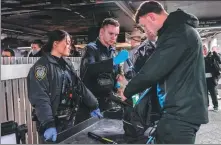  ?? ADAM GRAY / AGENCE FRANCE-PRESSE ?? New York police personnel conduct inspection­s at the Grand Central Station in New York on Wednesday.