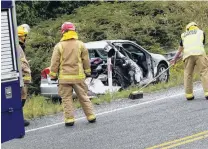  ?? PHOTO: RICHARD DAVISON ?? Cleaning up . . . Balclutha fire officers sweep State Highway 1 clear of glass after a crash just north of the town yesterday morning.