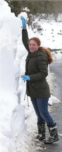  ?? Photo: Damien Eagers ?? Amy O’Neill, from Kilteel, Co Kildare, shows the towering level of snow that still remains in the local area days after Storm Emma battered the country.