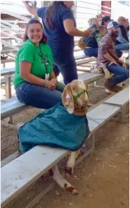  ?? PHOTO FOR THE RECORDER BY JAMIE A. HUNT ?? Gloria Soto sat watching the hog judging, along with her goat, West at the Portervill­e Fair Jr. Livestock show. She said, “I’m going to miss him.”