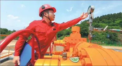  ?? ZHONG MIN / FOR CHINA DAILY ?? A worker from China National Petroleum Corp checks the figures on a gauge.