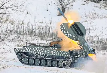  ?? ?? Ukrainian paratroope­rs on the frontline near Stanytsia Luhanska, in eastern Ukraine, above left; the engineers of the Guard of the Red-Snow of Russia’s armed forces in Voronezh, east of Ukraine’s border, above right