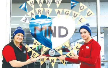  ??  ?? Coles staff members Fiona Voumard and Ethan Phillips thank shoppers after the Warragul store ranked second across Australia for “Big Freeze” FightMND beanie sales.