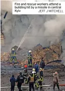  ?? JEFF J MITCHELL ?? Fire and rescue workers attend a building hit by a missile in central Kyiv