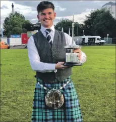  ??  ?? Fergus Bryce holding the World Championsh­ip trophy.