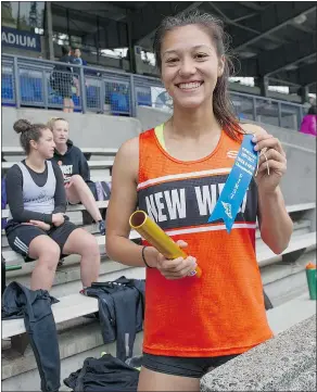  ?? JASON PAYNE/ PNG ?? New Westminste­r‘s Nina Schultz shows off her first-place ribbon after competing in the 4x100 relay during a competitio­n at Swangard Stadium in Burnaby this week.