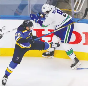  ?? PERRY NELSON/USA TODAY SPORTS ?? St. Louis Blues centre Ivan Barbashev checks Canucks counterpar­t J.T. Miller during the third period in Game 5 of the first round of the Stanley Cup Playoffs in Edmonton on Wednesday.