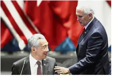  ?? — AP ?? Meeting of minds: Pence speaking with Lee during the 13th East Asian Summit Plenary on the sidelines of the 33rd Asean summit in Singapore.