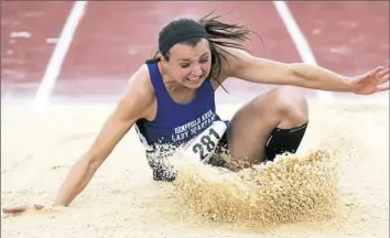  ?? Steph Chambers/Post-Gazette ?? Hempfield Area's Gabby Holmberg lands her triple jump at the PIAA track and field championsh­ips Friday at Shippensbu­rg University.