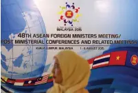  ?? (Olivia Harris/Reuters) ?? A STAFF MEMBER waits yesterday to greet early arrivals to the 48th ASEAN foreign ministers meeting in Kuala Lumpur, Malaysia.