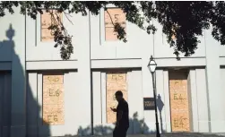  ?? JACK GRUBER/USA TODAY ?? The Wells Fargo Bank Building on Meeting Street in Charleston, S.C., is boarded up in preparatio­n for Hurricane Florence making landfall.