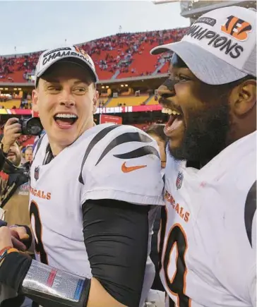  ?? DAVID EULITT/GETTY ?? Joe Burrow, left, and defensive tackle Tyler Shelvin celebrate after the Bengals won the AFC Championsh­ip.