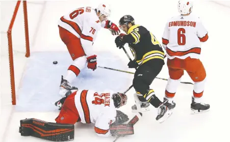 ?? GETTY IMAGES ?? Bruins forward David Krejci scores 57 seconds into the third period against Hurricanes goalie Petr Mrazek in Game 1 of their first-round playoff series on Wednesday at Scotiabank Arena in Toronto. Patrice Bergeron scored in overtime to secure the Bruins’ victory.