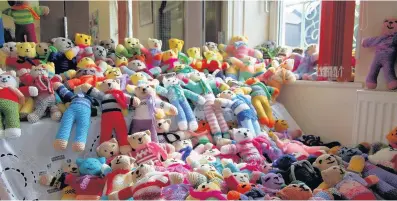  ??  ?? > Ladies involved in Pontyclun’s Yarnmonger­s knitting group have created 238 ‘trauma teddies’ for patients needing emergency care