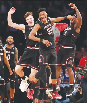  ?? Associated Press ?? On to the Elite Eight: South Carolina players celebrate after beating Baylor 70-50 in an East Regional semifinal game of the NCAA men's college basketball tournament on Friday in New York.