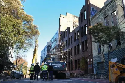  ?? Photograph: Dean Lewins/AAP ?? Arson squad investigat­ors and specialist­s will examine the scene of last week’s fire that destroyed a Surry Hills building in central Sydney after it is made safe by demolition workers.