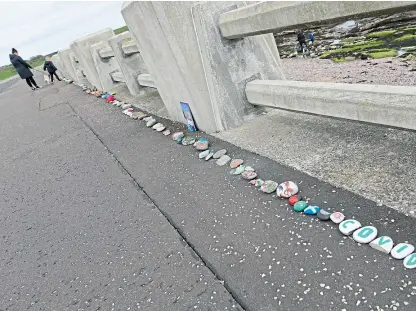  ?? Picture: Dougie Nicolson. ?? Some of the personalis­ed stones which make up the tribute in Arbroath.