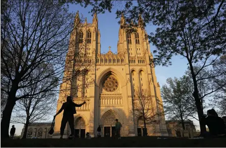  ?? PHOTOS BY CAROLYN KASTER — THE ASSOCIATED PRESS ?? The Washington National Cathedral is seen at sunset on April 13. Washington National Cathedral has chosen contempora­ry artist Kerry James Marshall, renowned for his wide-ranging works depicting African-American life, to design new stained-glass windows with themes of racial justice to replace windows with Confederat­e imagery that were removed from the landmark sanctuary in 2017.