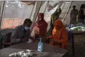  ?? NARIMAN EL-MOFTY — THE ASSOCIATED PRESS ?? Tigray refugees who fled a conflict in the Ethiopia’s Tigray region receive treatment at a clinic run by MSF (Doctors Without Borders) in Village 8, the transit center near the Lugdi border crossing, eastern Sudan, on Tuesday.