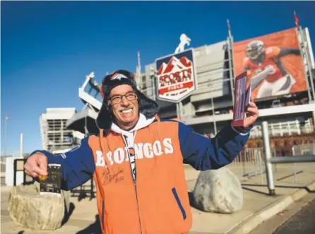  ??  ?? Denver Broncos season- ticket holder Mark Bodenstein of Aurora proudly displays the Super Bowl tickets he purchased at Sports Authority Field at Mile High onWednesda­ymorning. He was among the first in line. Joe Amon, The Denver Post