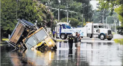  ?? Daniel Sangjib Min ?? The Associated Press A trash truck is stuck in flooding water Friday in Henrico, Va. The National Weather Service in Wakefield issued a flood warning around 6:30 a.m. for Richmond and areas east of the city.