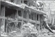  ?? AP/HASSAN AMMAR ?? A Syrian man sits on the back of a truck Thursday after retrieving furniture from his destroyed house in the mountain resort town of Zabadani in the Damascus countrysid­e of Syria. Meanwhile, a U.S. airstrike hit in the desert near the border with...