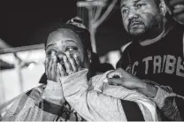  ?? Marcus Yam / Associated Press ?? Latrice Radford is consoled outside the Gable House Bowl in Torrance, Calif., where three people were killed by gunfire.