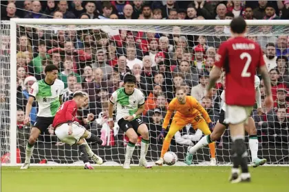  ?? DAVE THOMPSON — THE ASSOCIATED PRESS ?? Manchester United’s Antony, second left, scores his side’s second goal during the FA Cup quarterfin­al against Liverpool at the Old Trafford stadium in Manchester, England on Sunday.