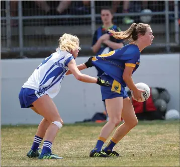  ??  ?? Laura Nerney from Laois pulls the jersey ofWicklow’s Laurie Ahern during the TG4 Ladies Leinster Intermedia­te football final in Netwatch Cullen Park last Sunday. Photo: Joe Byrne