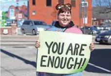  ?? PROVIDED BY SOFIA HORNBEAK ?? Emily-Sue Snyder, 32, holds a sign at an event for her “Stay Another Day: Suicide Prevention and Awareness” mission in Sapulpa, Okla., in February.