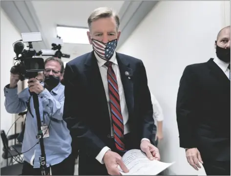  ?? J. SCOTT APPLEWHITE/AP ?? REPUBLICAN REP. PAUL GOSAR OF ARIZONA, leaves his office as the House of Representa­tives prepares to vote on a resolution to formally rebuke him for tweeting an animated video that depicted him striking Rep. Alexandria Ocasio-Cortez, D-N.Y., with a sword, on Capitol Hill in Washington Wednesday.