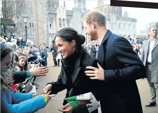  ?? Picture: Getty Images ?? Prince Harry and his fiancée Meghan Markle, who met on a blind date, greeting children at Cardiff Castle in January.