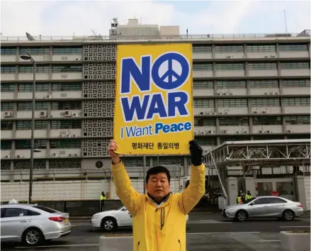  ?? (Photo by Ahn Young-joon, AP) ?? A protester holds up a banner to oppose the United States' policies against North Korea near U.S. Embassy in Seoul, South Korea, Friday, Dec. 22, 2017. The U.N. Security Council is meeting Friday to vote on whether to impose new sanctions on North...