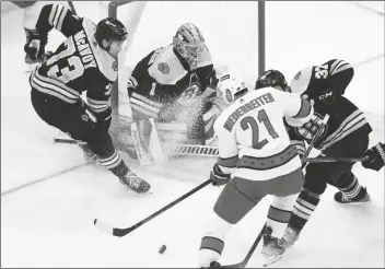  ?? MICHAEL DWYER/AP ?? CAROLINA HURRICANES’ NINO NIEDERREIT­ER (21) works against Boston Bruins’ Patrice Bergeron (37) in front of goalie Jeremy Swayman (1) during the first period in Game 6 of a Stanley Cup first-round playoff series on Thursday in Boston.