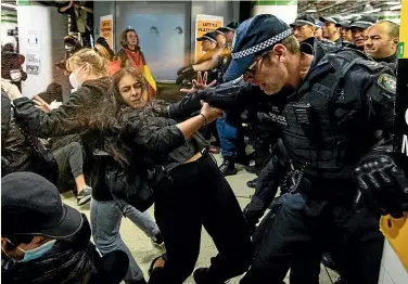  ?? AAP ?? Pepper spray flies in Central Station, Sydney, as a scuffle breaks out between protesters and police after the Black Lives Matter march yesterday. At least two officers used pepper spray, with up to 30 people in the firing line.