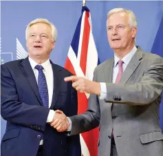  ??  ?? Davis (left) shake hands with Barnier prior to their meeting at the European Union Commission headquarte­rs in Brussels. — AFP photo