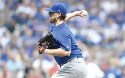  ?? | STACY REVERE/ GETTY IMAGES ?? Cubs right- hander John Lackey allowed three earned runs in four innings Friday against the Brewers.