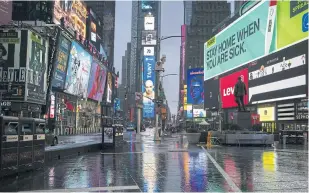  ??  ?? Times Square in New York City was mostly devoid of people last Thursday.