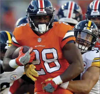  ??  ?? Denver Broncos running back Royce Freeman (28) is hit by Pittsburgh Steelers linebacker L.J. Fort (54) during the first half of an NFL football game, on Sunday, in Denver. AP PHOTO/DAVID ZALUBOWSKI