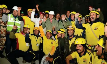  ?? ?? Unidentifi­ed rescue workers cheer after helping to free the trapped men in the tunnel. Photograph: AP