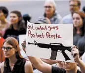  ?? LUKE SHARRETT/GETTY ?? An activist expresses her displeasur­e Aug. 6 outside the office of Senate Majority Leader Mitch McConnell, R-Ky., in Louisville after mass shootings in Texas and Ohio.