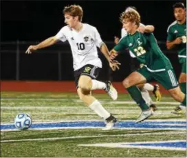  ?? TRENTONIAN FILE PHOTO ?? Hopewell’s Luke Tartaglia, left, had the winning goal from the spot against Lawrence on Wednesday.