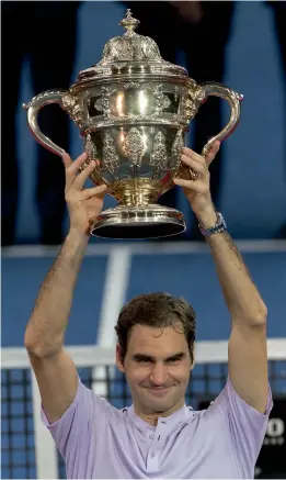  ?? —AP ?? Roger Federer poses with the trophy after beating Juan Martin del Potro in the final of the Swiss Indoors tennis tournament in Basel.