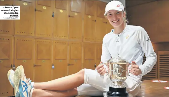  ?? Corinne Dubreuil/AP ?? French Open women’s singles champion Iga
Swiatek