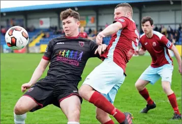  ??  ?? Centre-forward Craig Hayes comes under pressure from Anthony O’Donnell of Cobh Ramblers.
