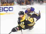  ?? Adam Glanzman / Getty Images ?? The Bruins’ Brad Marchand battles for the puck with the Blues’ Carl Gunnarsson during the third period in Game 2 of the Stanley Cup Finals on Wednesday in Boston.